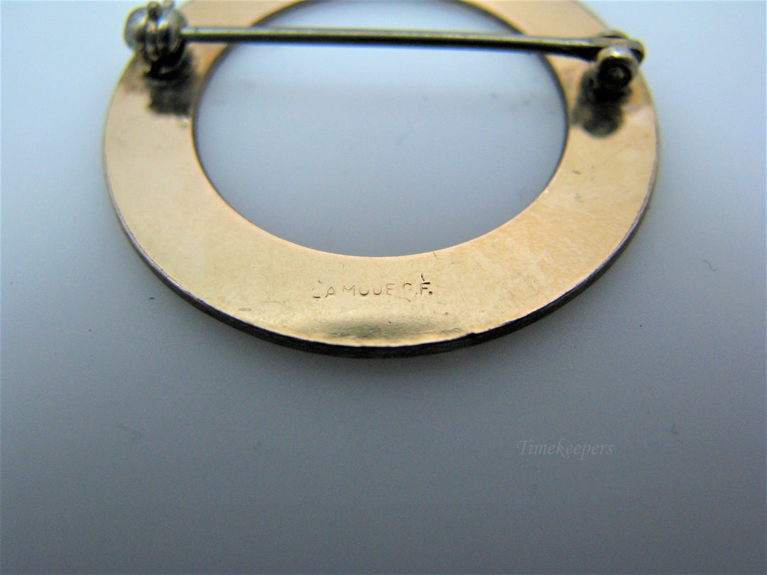 j209 Pretty LaMode Gold Filled Circle Brooch embossed with a Design