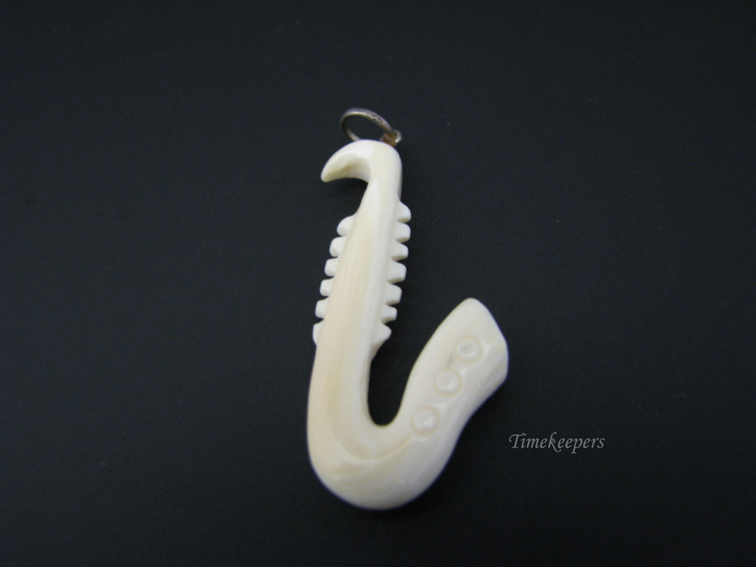 c673 Vintage Carved Bone Saxaphone Pendant/ Charm