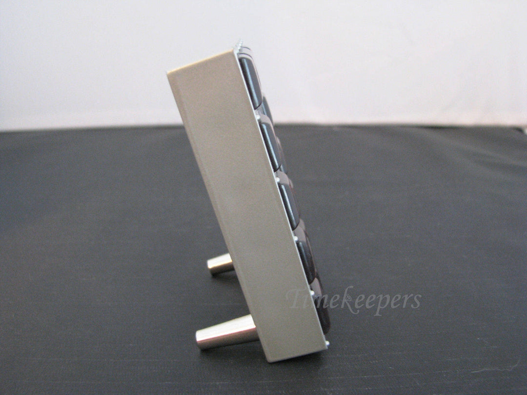 c134 Nice Desk Miniature Clock in a Silver tone Resin with Brown Plastic Gems