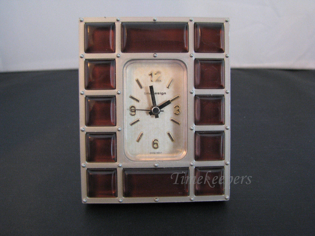 c134 Nice Desk Miniature Clock in a Silver tone Resin with Brown Plastic Gems