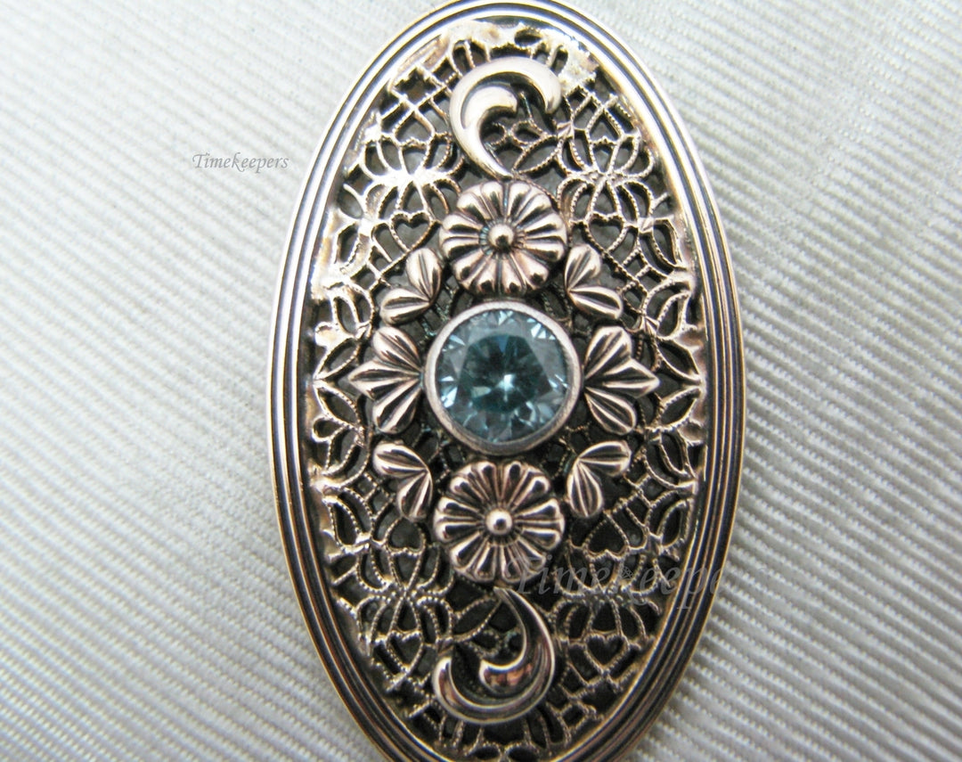 c510 Stunning Symmetalic Large Oval Floral Pendant with Center Blue Zircon