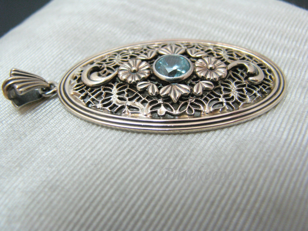 c510 Stunning Symmetalic Large Oval Floral Pendant with Center Blue Zircon