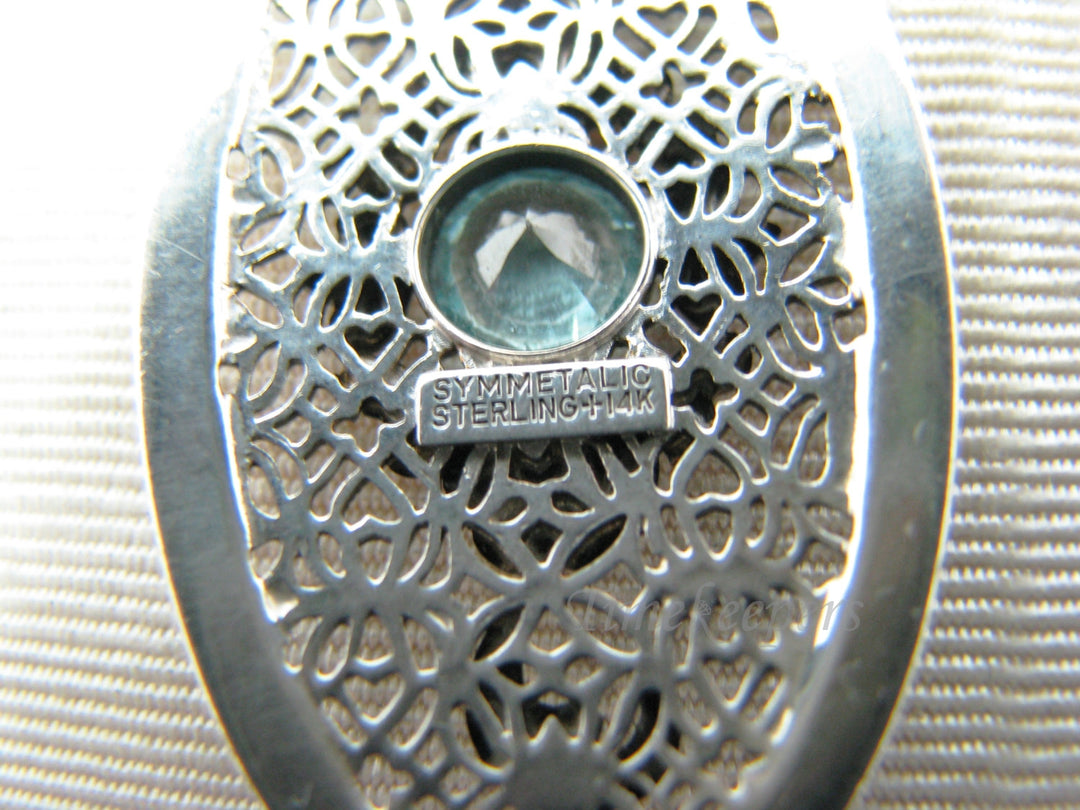 c510 Stunning Symmetalic Large Oval Floral Pendant with Center Blue Zircon