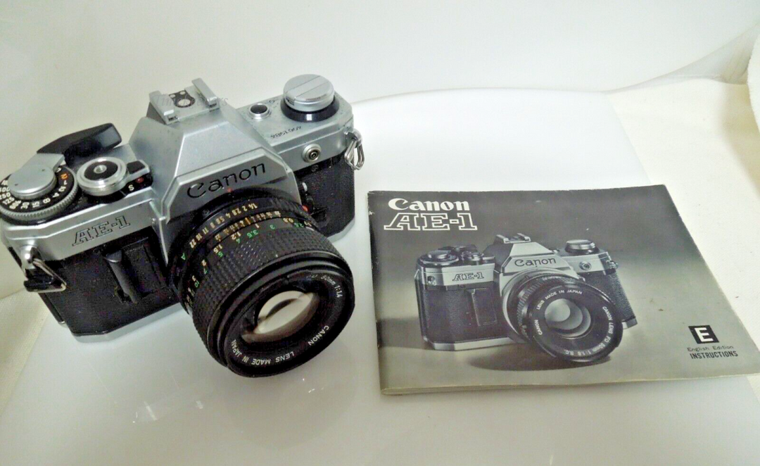 s606 Canon AE-1 35mm SLR w/50mm 1:1.4 and Manual Booklet